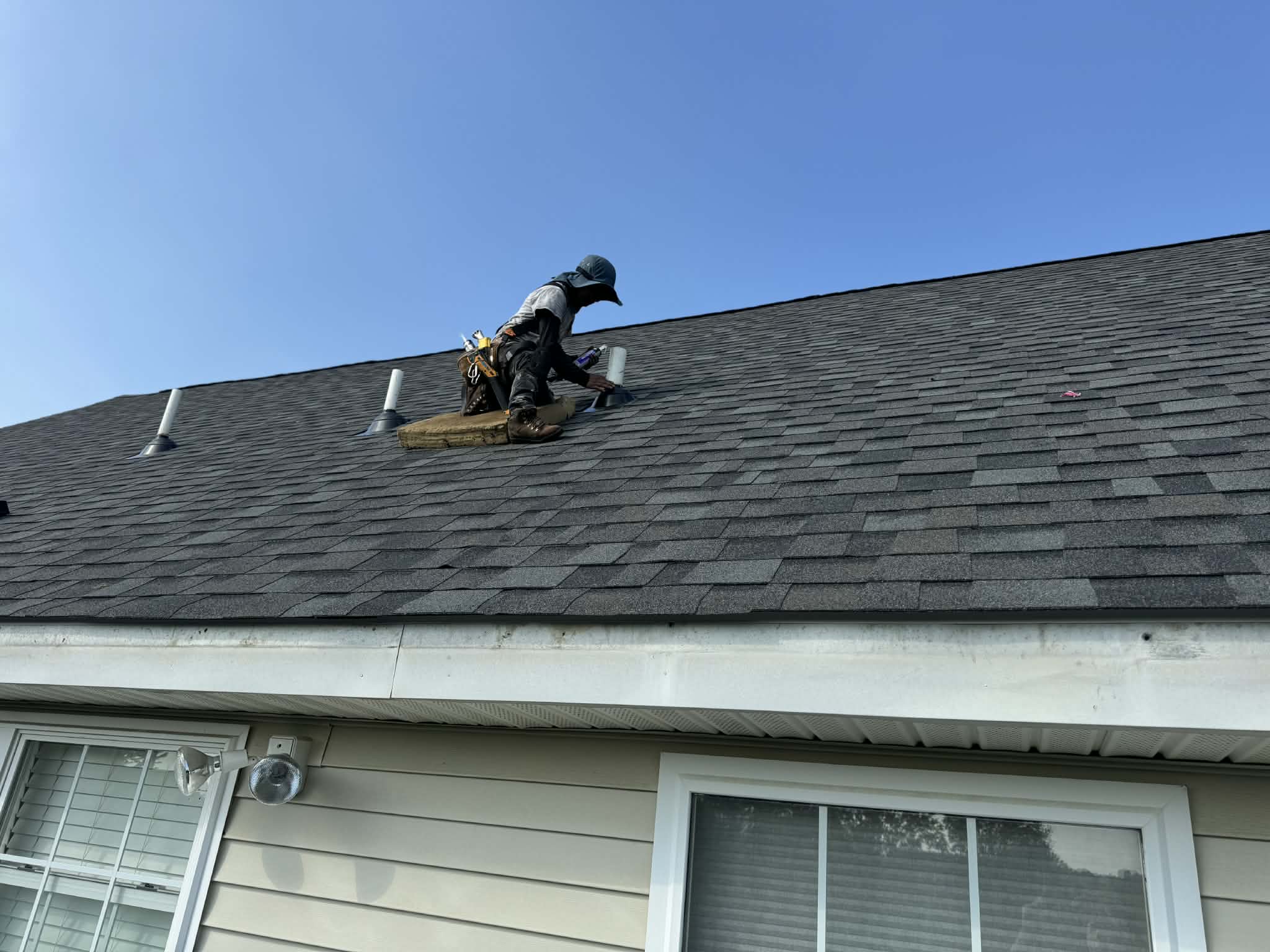 Licensed roofing professional inspecting a completed roof replacement in New Jersey