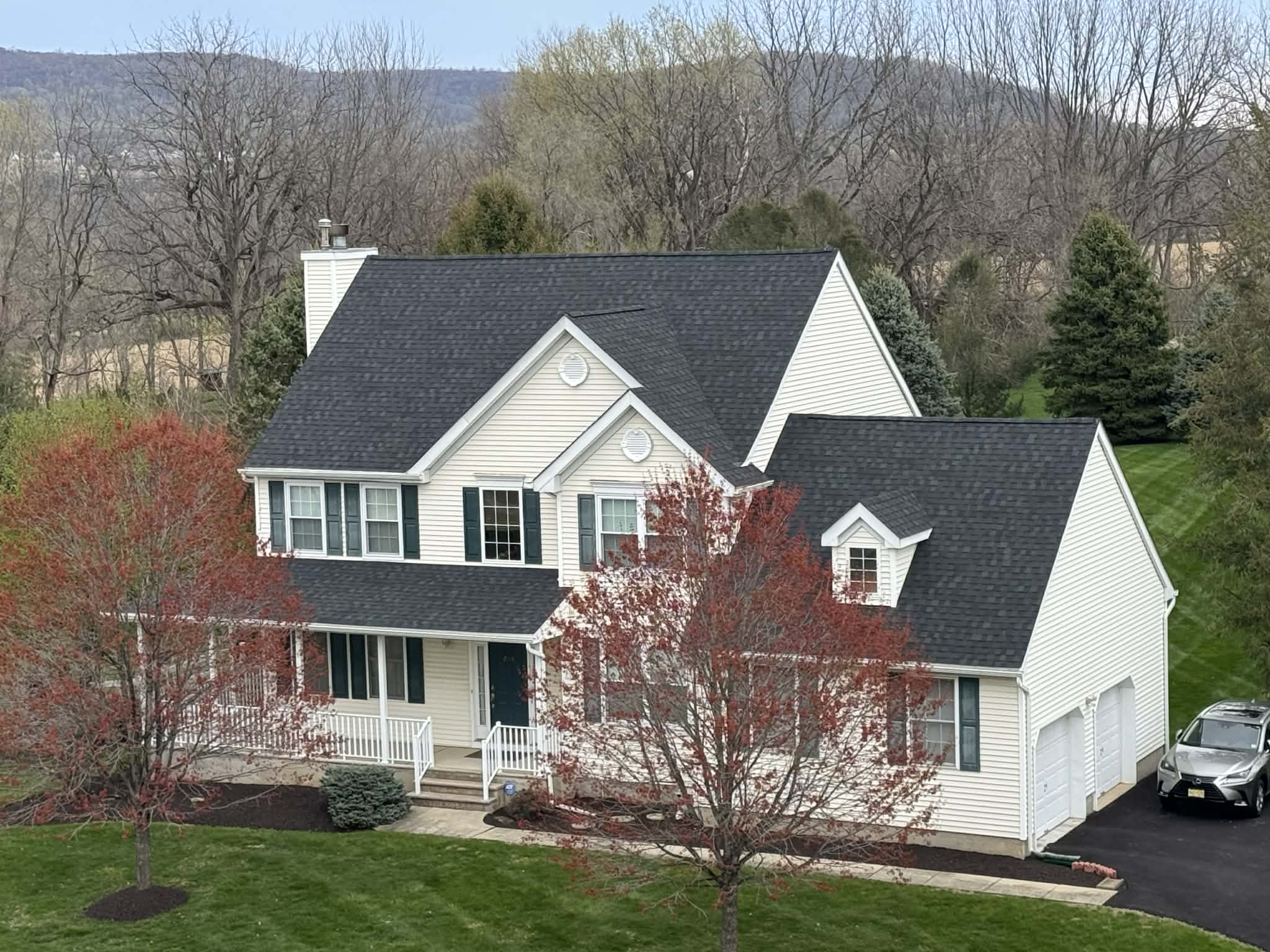 New Jersey roofing contractor measuring a residential roof for replacement estimate