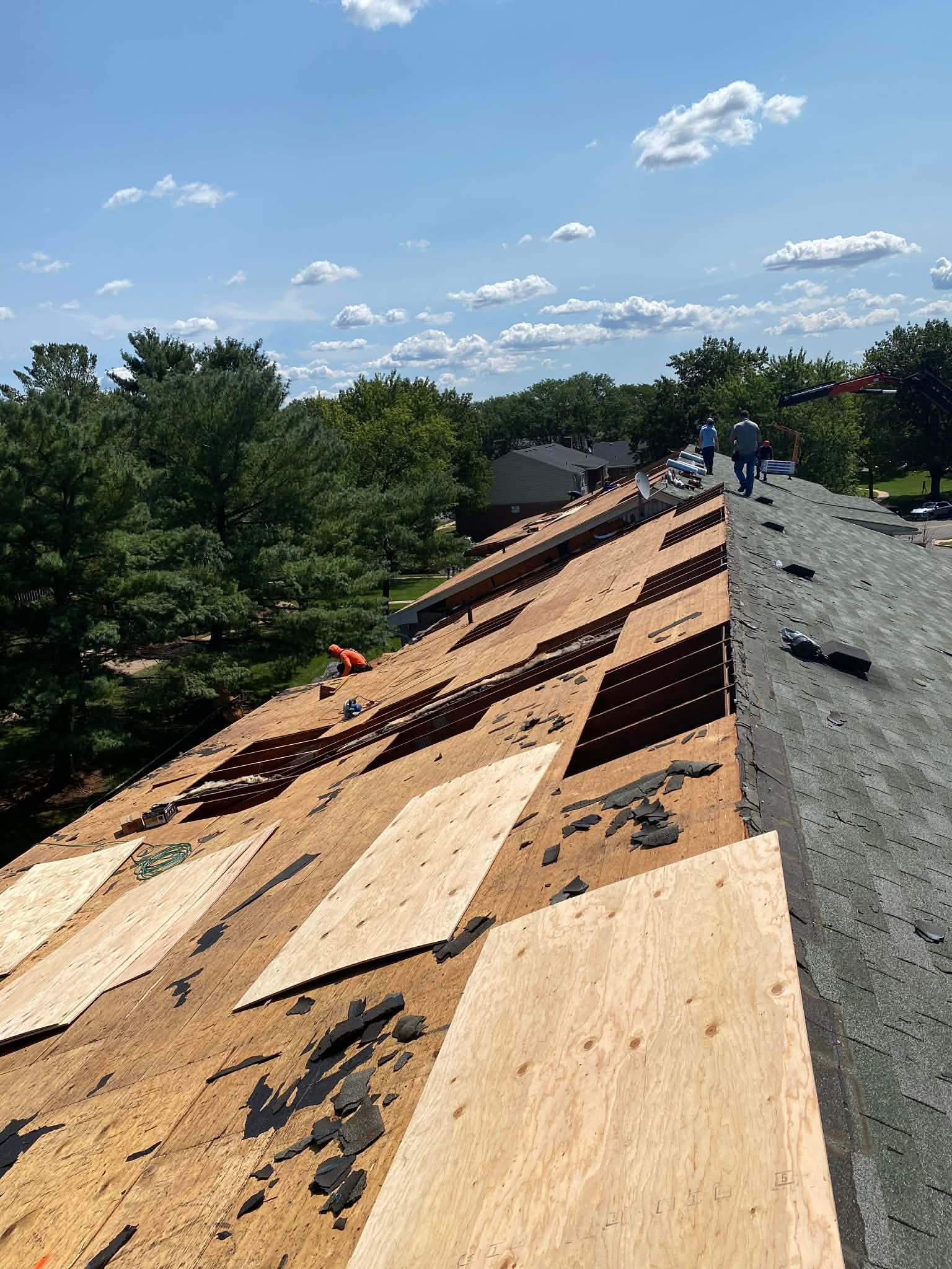 Roofing repair work stabilizing a sagging roof with professional tools